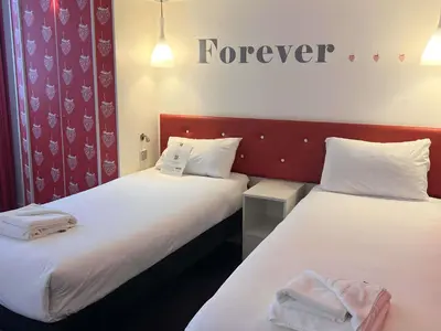 two beds in a room with a forever sign on the wall at Ibis Styles Liverpool Centre Dale Street - Cavern Quarter in Liverpool