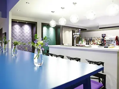 a dining room with a table and a bar at Ibis Styles Liverpool Centre Dale Street - Cavern Quarter in Liverpool