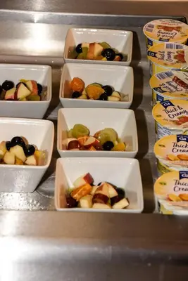 four styrofoam containers of fruit in a refrigerator at Stuart hotel in Blackpool