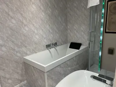 a bathroom with a white sink and a toilet at Stuart hotel in Blackpool