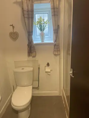 a bathroom with a toilet and a window at Sarnia holiday flats in Blackpool