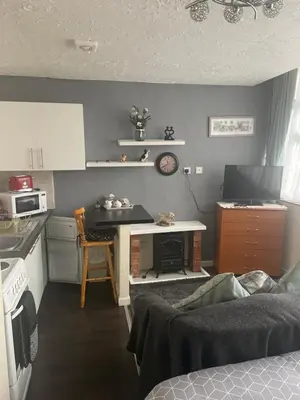 a small kitchen with a table and a counter top at Sarnia holiday flats in Blackpool