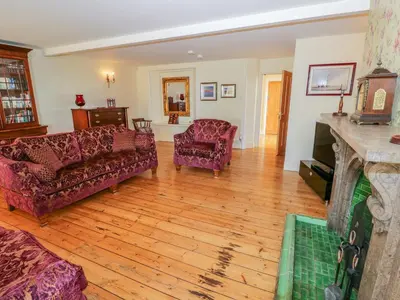 a living room with two couches and a fireplace at Villa Marina in Barrow in Furness