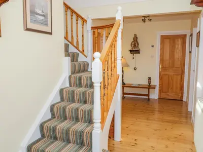 a staircase in a home with a striped rug at Villa Marina in Barrow in Furness