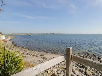 a wooden fence on the shore of a body of water at Villa Marina in Barrow in Furness