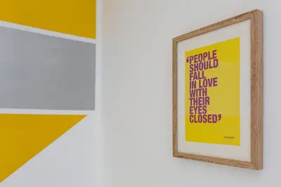 a framed poster on a wall in a room at Cosy Anfield Guesthouse - Close to Stadium & City in Liverpool