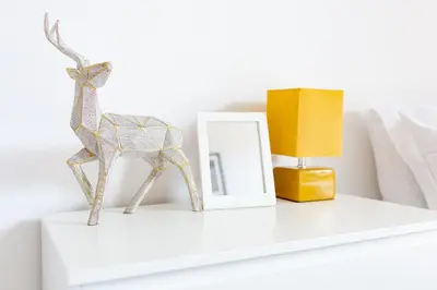 a white shelf with a figurine of a deer on it at Cosy Anfield Guesthouse - Close to Stadium & City in Liverpool
