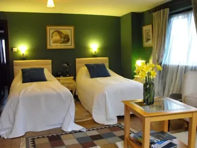 two beds in a room with green walls at Whitmore in Lancaster
