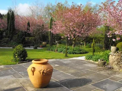 a large vase sitting on the ground in a garden at Whitmore in Lancaster