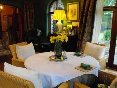 a table with a vase of yellow flowers on it at Whitmore in Lancaster