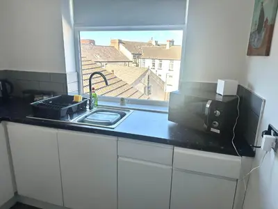 a kitchen counter with a microwave and a window at Blackpool Tower Apartments by Blackpool Service Aparttments in Blackpool
