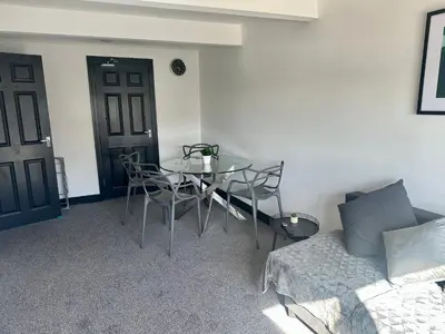 a room with a table and chairs and a couch at Blackpool Tower Apartments by Blackpool Service Aparttments in Blackpool