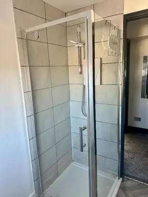 a shower with a glass door in a bathroom at Blackpool Tower Apartments by Blackpool Service Aparttments in Blackpool
