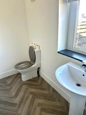 a bathroom with a toilet and a sink and a window at Blackpool Tower Apartments by Blackpool Service Aparttments in Blackpool