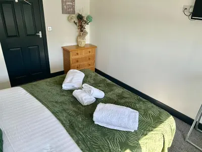a bedroom with a bed with two towels on it at Blackpool Tower Apartments by Blackpool Service Aparttments in Blackpool