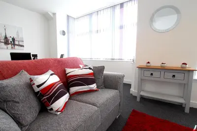 a living room with a couch and a table at Blackpool Tower Apartments by Blackpool Service Aparttments in Blackpool