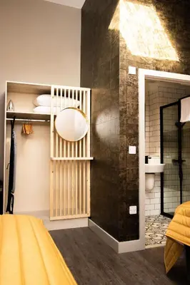 a bedroom with a yellow bed and a black wall at York Street Studios in Liverpool