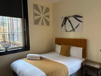 a small bedroom with a bed and a window at York Street Studios in Liverpool