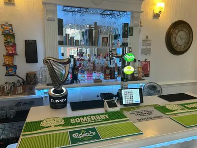 a counter in a bar with a phone and aorah at North Crest in Blackpool