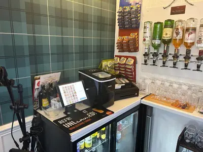 a coffee shop with a counter with a cash register at North Crest in Blackpool