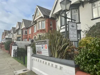 a row of houses with signs in front of them at North Crest in Blackpool