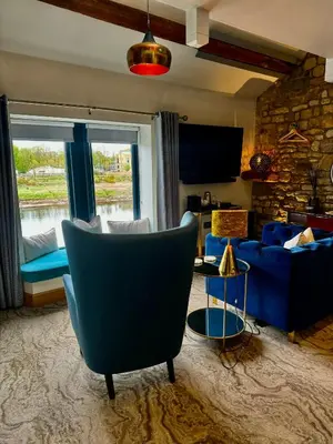 a living room with a couch and a chair at Quite Simply French in Lancaster