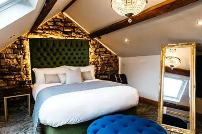 a bedroom with a large bed and a mirror at Quite Simply French in Lancaster