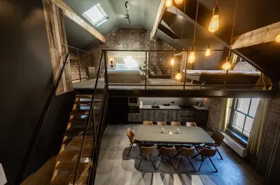 a dining room with a table and some chairs at The Loft Sasco Apartments in Blackpool