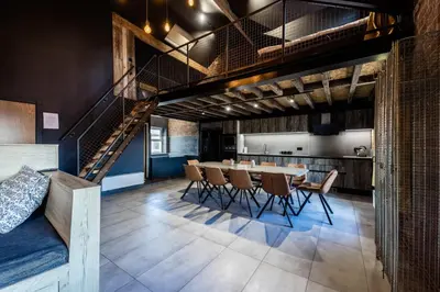 a dining room with a long table and chairs at The Loft Sasco Apartments in Blackpool