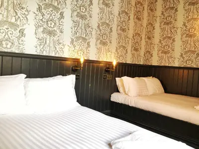 two beds sitting next to each other in a room at The Residence Sasco Apartments in Blackpool