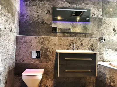 a bathroom with a toilet and a sink and a mirror at The Residence Sasco Apartments in Blackpool