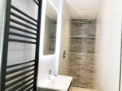 a bathroom with a toilet and a sink and a shower at The Residence Sasco Apartments in Blackpool
