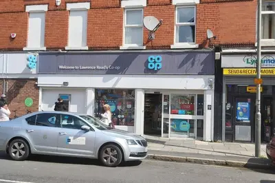 a silver car parked in front of a store at Bright, Comfortable Home, Convenient for City Centre in Liverpool