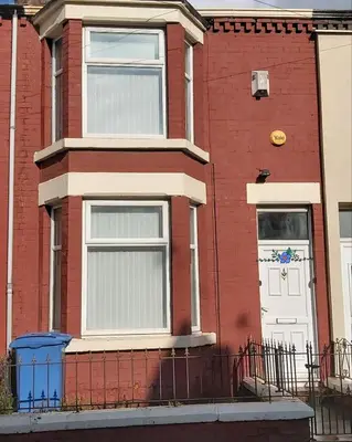 a red brick house with a white door at Bright, Comfortable Home, Convenient for City Centre in Liverpool