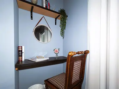 a table with a chair and a mirror on a wall at Botanic Rooms in Liverpool