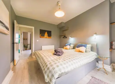 a bedroom with a large bed in a room at Botanic Rooms in Liverpool