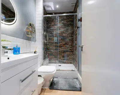a bathroom with a shower and a toilet and a sink at Botanic Rooms in Liverpool