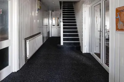 a hallway with a staircase in a house at Harlands Hotel in Blackpool