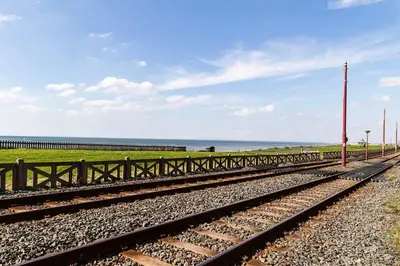 a pair of train tracks with the ocean in the background at Harlands Hotel in Blackpool