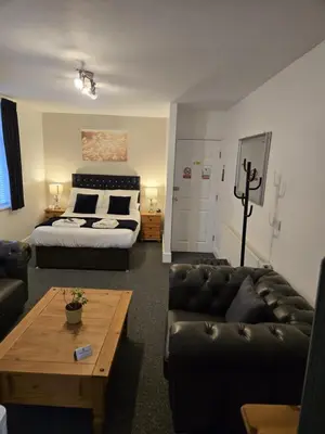 a living room with a bed and a couch at Q Accommodation in Blackpool