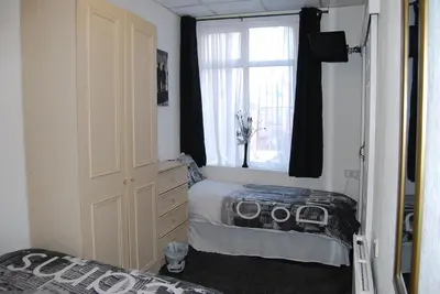 a bedroom with a window and a bed in it at Birch Villa in Blackpool