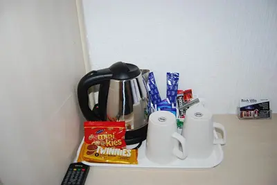 a counter with a coffee pot and cups on it at Birch Villa in Blackpool