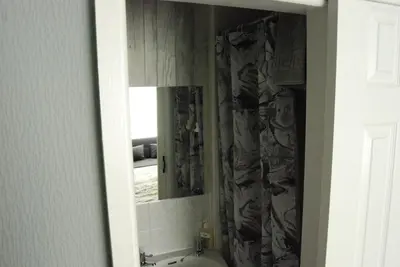 a bathroom with a mirror and a sink at Birch Villa in Blackpool