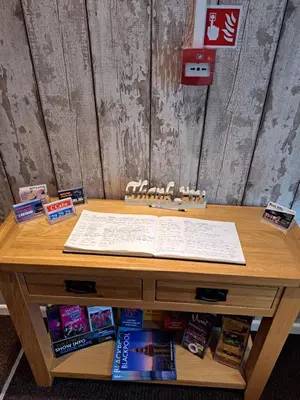 a wooden table with an open book on top of it at Birch Villa in Blackpool