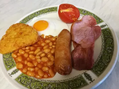 a plate of breakfast food with eggs beans bacon and toast at Birchhouse in Blackpool