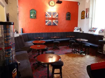 a restaurant with tables and chairs in a room at Hilbre Hotel in Blackpool