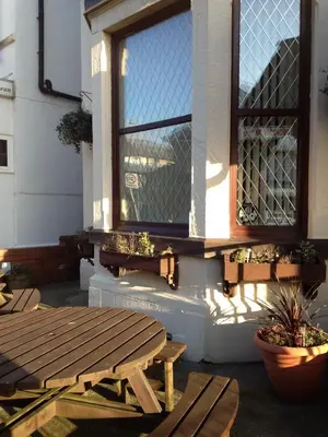 a picnic table and a window on the side of a building at Hilbre Hotel in Blackpool