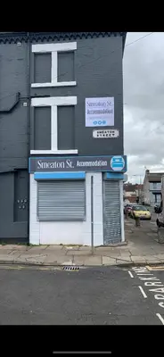 a building with a sign on the side of a street at Smeaton serviced Accommodation in Liverpool