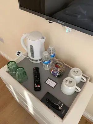 a table with a coffee maker and other items on it at Smeaton serviced Accommodation in Liverpool