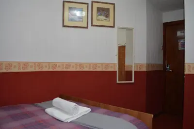 a bedroom with a bed with two towels on it at BLACKPOOL MERCY Inn HOTEL in Blackpool